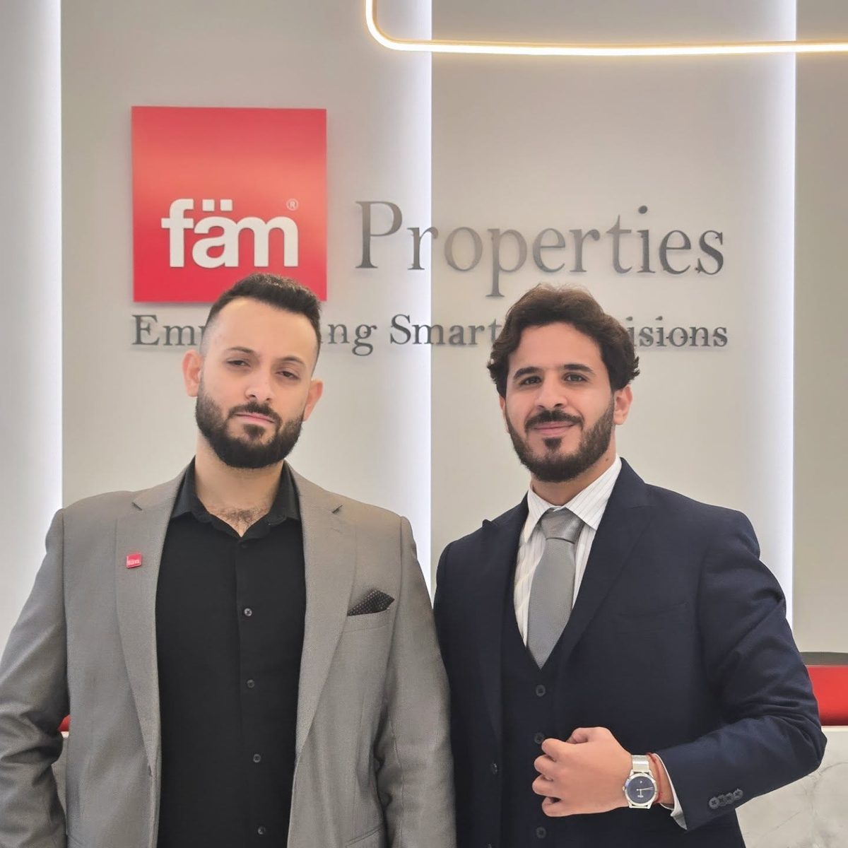 Mo Daas at the fäm Properties logo wall